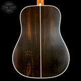 Close-up of a guitar's back with a dark wood finish on a black background, featuring the Tone Shop logo.