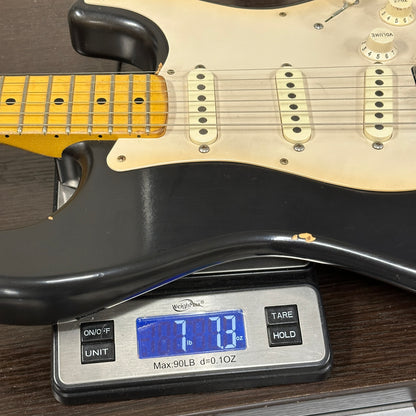 Guitar on a digital scale displaying weight