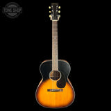 A vintage-style acoustic guitar with a natural-to-black sunburst finish, shown against a solid black background. The brand 'Martin' is visible on the headstock, and a 'TONE SHOP' watermark is in the top-left corner.