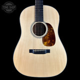 Acoustic guitar with a visible brand logo in the corner