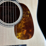 Close-up of an acoustic guitar's soundhole and body