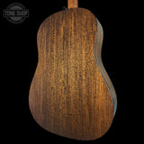 Close-up of a wooden acoustic guitar back with 'Tone Shop' logo.