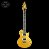 A gold-finish electric guitar with a dark fretboard and gold hardware, shown vertically against a solid black background. A 'TONE SHOP' watermark is visible in the top-left corner.