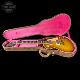 Gibson Les Paul guitar in a pink case with 'Tone Shop' logo.