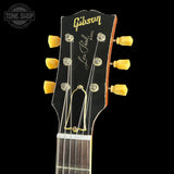 Gibson Les Paul guitar headstock with tuning pegs on a black background
