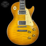 Electric guitar with a sunburst finish on a black background, featuring the Tone Shop logo.