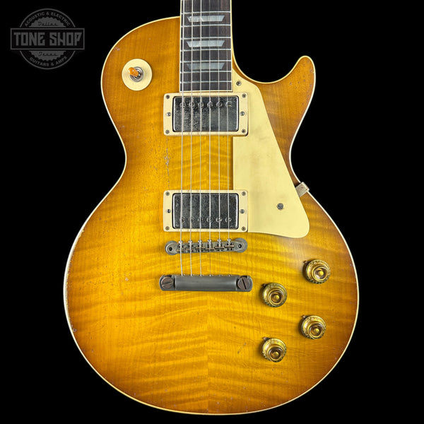 Electric guitar with a sunburst finish on a black background, featuring the Tone Shop logo.