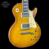 Electric guitar with a sunburst finish on a black background, featuring the Tone Shop logo.