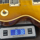 Guitar on a digital scale displaying weight