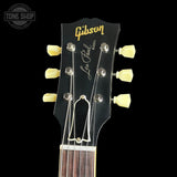 Gibson Les Paul guitar headstock with brand logo on a black background
