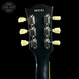 Guitar headstock with tuning pegs on a black background, featuring 'Tone Shop' logo.