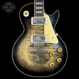 Electric guitar with a sunburst finish on a black background, featuring the Tone Shop logo.