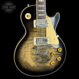 Electric guitar with a sunburst finish on a black background, featuring the Tone Shop logo.
