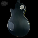 Black electric guitar body with 'Tone Shop' logo in the corner