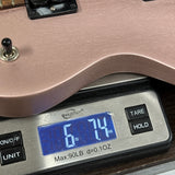 Used 2023 Gibson Les Paul Modern Lite Rose Gold Satin on scale displaying weight.