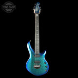 Blue electric guitar on a black background with 'Tone Shop' logo.