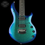 Blue glitter electric guitar on a black background with 'Tone Shop' logo.