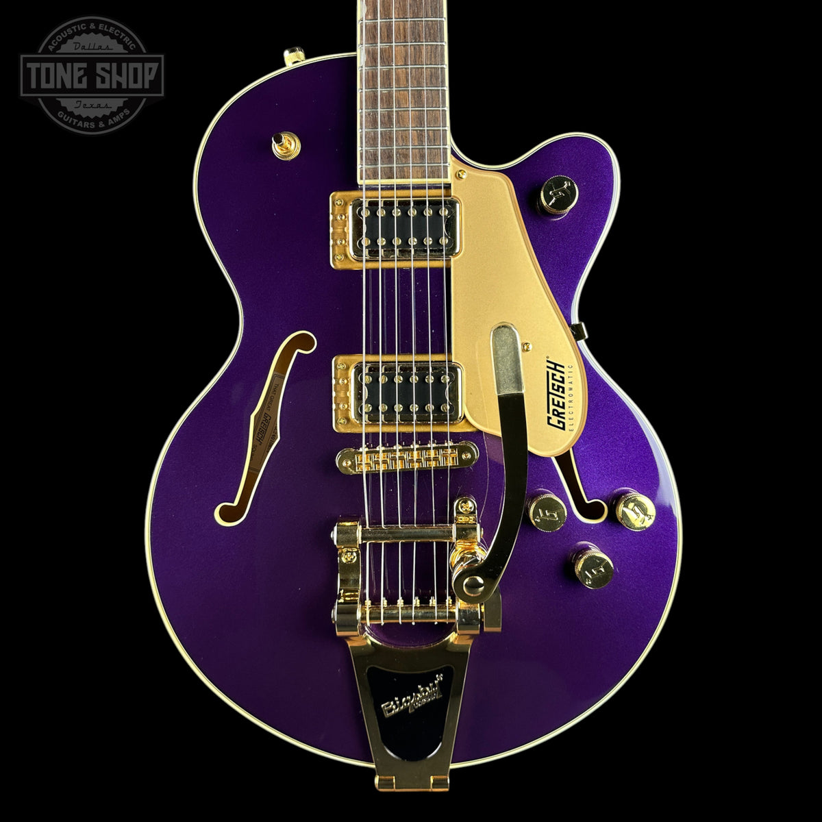 A purple metallic Gretsch electric guitar with gold hardware and a cream pickguard, shown against a solid black background. The Tone Shop logo is visible in the top-left corner.