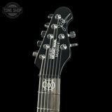 Guitar headstock with 'Ibanez' branding on a black background