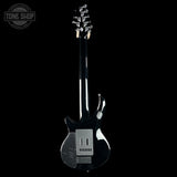 Black electric guitar with a unique design on a black background, featuring the Tone Shop logo.