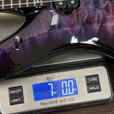 Guitar on a digital scale displaying weight
