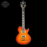 A Gibson Les Paul Custom electric guitar with a vibrant sunburst flame finish, shown vertically against a solid black background. The guitar features a dark wood neck, gold hardware, and a white Gibson headstock.