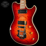 Electric guitar with a red flame finish on a black background, featuring the Tone Shop logo.