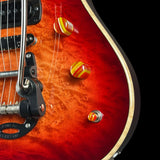 Close-up of a red electric guitar with a black pickguard on a black background