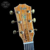Guitar headstock with brand logo on a black background