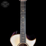 Close-up of a guitar with a black background and 'Tone Shop' logo.