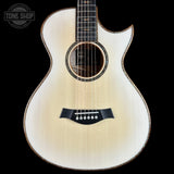 Acoustic guitar with a visible brand logo on a black background