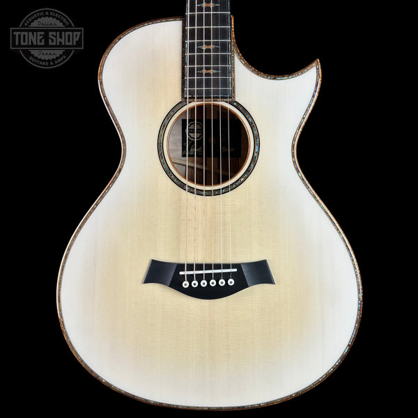 Acoustic guitar with a visible brand logo on a black background