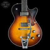 A close-up studio shot of an electric guitar against a black background, showing the body with a sunburst finish, chrome hardware, and a silver Floyd-Rumford tailpiece. A Tone Shop watermark is visible in the top left corner.
