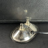 Vintage metallic device with a black leather background