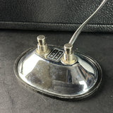 Vintage-style radio antenna on a dark surface
