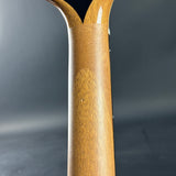 Close-up of a wooden tool handle on a dark gray background