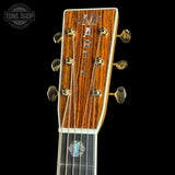 Close-up of a Martin guitar headstock with brand name on a black background