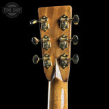 Close-up of a guitar headstock with tuning pegs on a black background, featuring the Tone Shop logo.