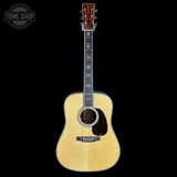 Acoustic guitar with a visible brand logo on a black background