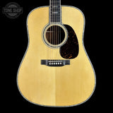 Acoustic guitar with a visible brand logo in the corner