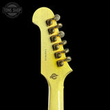 Close-up of a guitar's headstock with tuning pegs on a black background, featuring the Tone Shop logo.