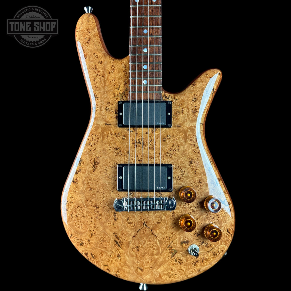 Wooden electric guitar with a visible brand logo on a black background
