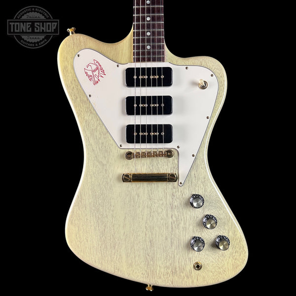White electric guitar with a distinctive design on a black background