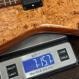 Digital scale displaying weight of a wooden object on a wooden surface