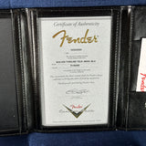 Fender certificate of authenticity in a black leather case on a blue background