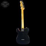 Black electric guitar with a blonde neck on a black background, featuring 'Tone Shop' branding.