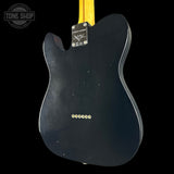 Black electric guitar body with 'Fender' branding on a black background