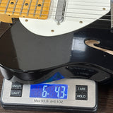 Guitar on a digital scale displaying weight