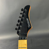 Guitar headstock with 'Kramer' branding on a gray background