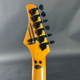 Guitar headstock with tuning pegs on a gray background
